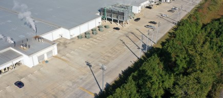 An IntelliRupter PulseCloser Fault Interrupter installed on a feeder on the outskirts of a manufacturing facility’s parking lot.